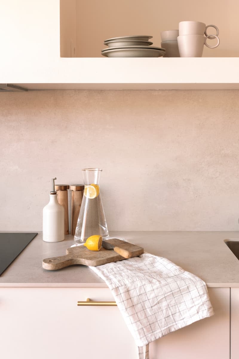 Water pitcher and lemon on kitchen countertop.