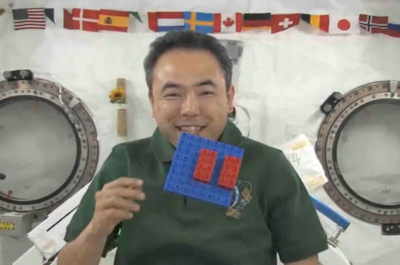 Japanese astronaut Satoshi Furukawa floats with LEGO (DUPLO) bricks aboard the International Space Station in 2011. The toys are now set to come home to Earth in March 2013.