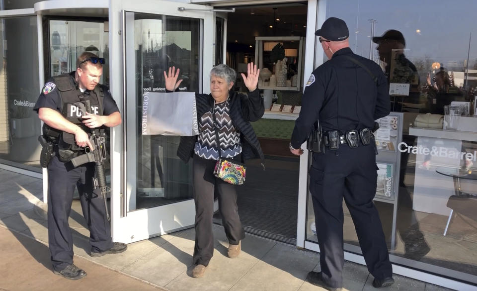 Shoppers are evacuated from Fashion Place Mall in Murray, Utah, after a shooting on Sunday, Jan. 13, 2019. (AP Photo/Rick Bowmer)