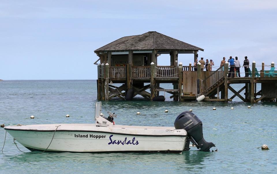 People gather on the resort's pier following the fatal attack