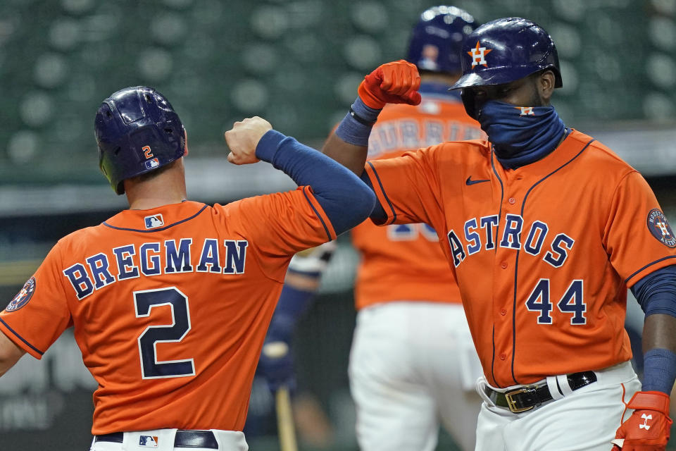 Houston Astros' Yordan Alvarez (44) celebrates with Alex Bregman (2) after both scored on Alvarez's three-run home run against the Seattle Mariners during the first inning of a baseball game Friday, Aug. 14, 2020, in Houston. (AP Photo/David J. Phillip)