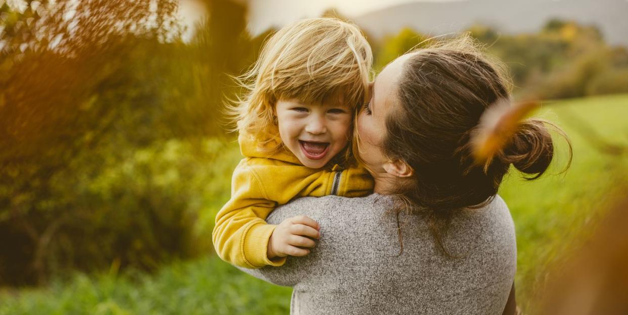 toddler playing with mother