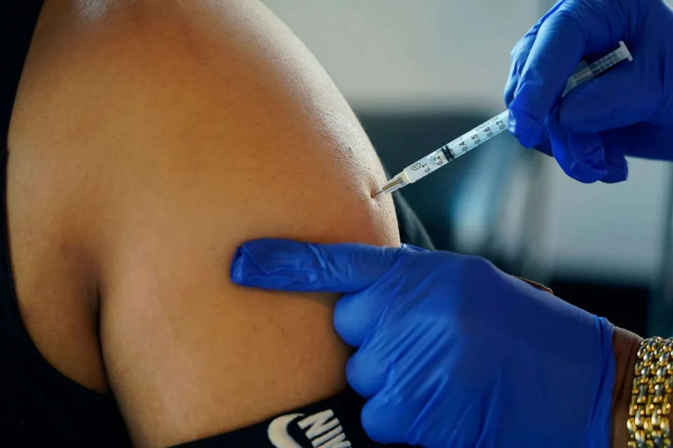 PHOTO: In this Feb. 8, 2022, file photo, a Jackson, Miss., resident receives a Pfizer booster shot from a nurse at a vaccination site. (Rogelio V. Solis/AP, FILE)