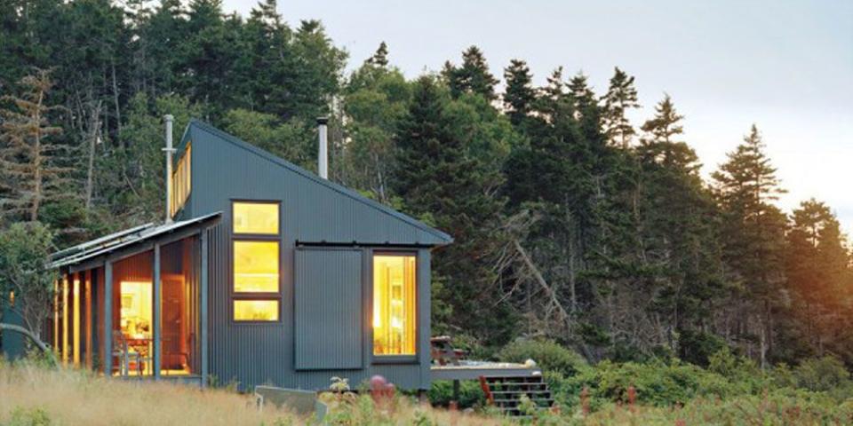 <p>This 550-square-foot Maine cottage has <a href="https://go.redirectingat.com?id=74968X1596630&url=http%3A%2F%2Fwww.homedepot.com%2Fp%2FGrape-Solar-400-Watt-Off-Grid-Solar-Panel-Kit-GS-400-KIT%2F203505963&sref=https%3A%2F%2Fwww.countryliving.com%2Fhome-design%2Fg1887%2Ftiny-house%2F" rel="nofollow noopener" target="_blank" data-ylk="slk:solar panels;elm:context_link;itc:0;sec:content-canvas" class="link ">solar panels</a> on the southeast-facing porch to collect energy (<a href="https://go.redirectingat.com?id=74968X1596630&url=https%3A%2F%2Fwww.walmart.com%2Fip%2FAPC-Back-UPS-Pro-1500VA-Uninterruptible-Power-Supply-External-Battery-Pack-for-BR1500G-Model-UPS-BR24BPG%2F23020903%3Fwmlspartner%3Dwlpa%26selectedSellerId%3D0%26adid%3D22222222227016460169%26wl1%3Dg%26wl2%3Dc%26wl3%3D40881691712%26wl4%3Dpla-78811919552%26wl5%3D9073477%26wl9%3Dpla_with_promotion%26wl10%3D8175035%26wl11%3Donline%26wl12%3D23020903%26veh%3Dsem&sref=https%3A%2F%2Fwww.countryliving.com%2Fhome-design%2Fg1887%2Ftiny-house%2F" rel="nofollow noopener" target="_blank" data-ylk="slk:auxiliary batteries;elm:context_link;itc:0;sec:content-canvas" class="link ">auxiliary batteries</a> can store at least a week's worth) to power the refrigerator and heat shower water. A <a href="https://www.homedepot.com/p/Ashley-Hearth-Products-1-200-sq-ft-2020-EPA-Certified-Wood-Burning-Stove-AW1120E-P/313268588" rel="nofollow noopener" target="_blank" data-ylk="slk:wood stove;elm:context_link;itc:0;sec:content-canvas" class="link ">wood stove</a>, anchored by a hearth made of local beach stones, radiates enough warmth for the entire building.</p><p><a class="link " href="https://www.countryliving.com/home-design/house-tours/a35775/daughter-builds-tiny-cottage-for-father/" rel="nofollow noopener" target="_blank" data-ylk="slk:SEE INSIDE;elm:context_link;itc:0;sec:content-canvas">SEE INSIDE</a></p>