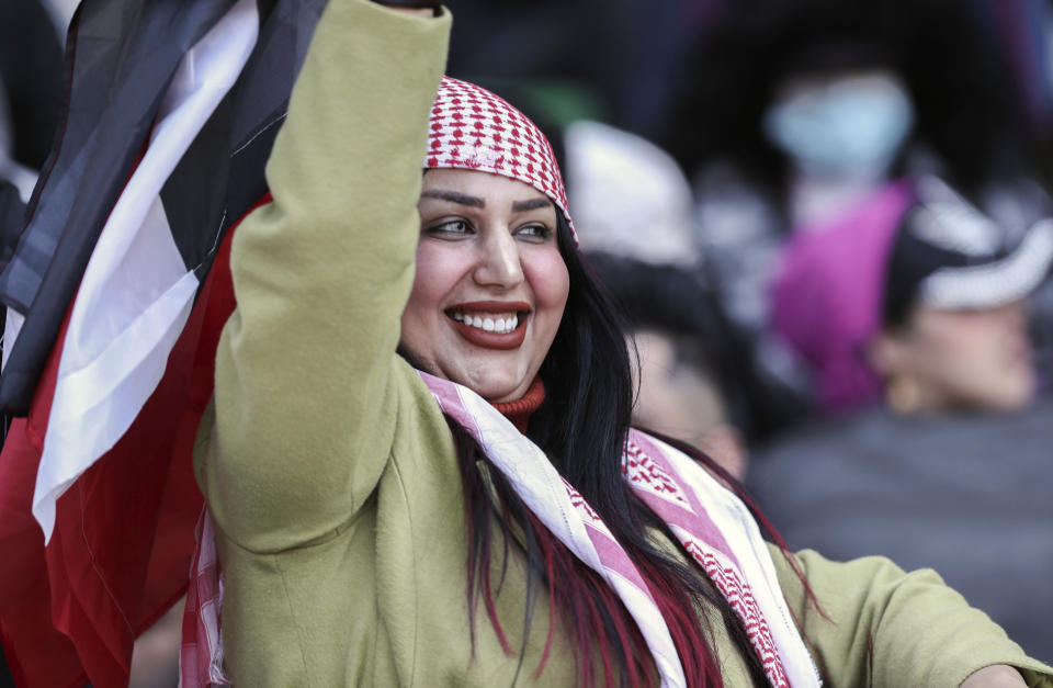 An Iraqi soccer fan waves her country flag inside the stadium before the Arabian Gulf Cup football final between Iraq and Oman at the Basra International Stadium in Basra, Iraq, Thursday, Jan 19, 2023. (AP Photo/Nabil al-Jurani)