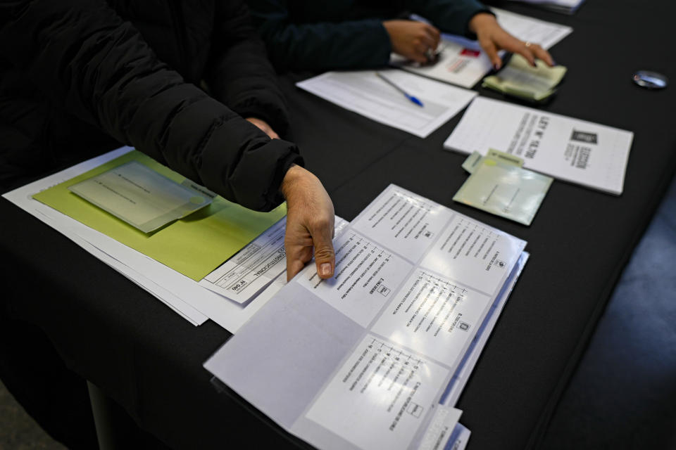 An electoral worker prepares election materials at the old Mapocho train station, now a cultural center, which will serve as one of the polling stations for the Constitutional Council election in Santiago, Chile, Friday, May 5, 2023. The election will be held May 7, after a first attempt to replace the current Constitution bequeathed by the military 42 years ago was rejected by voters in 2022. (AP Photo/Esteban Felix)