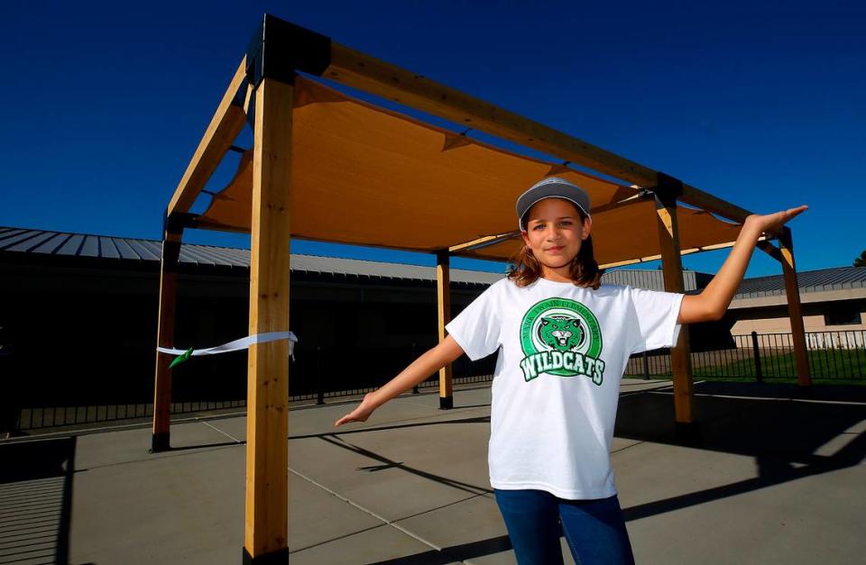 Genie Hernandez, a Mark Twain fifth-grade student, shows off her dream that became reality, an outdoor shaded classroom area in the courtyard of the Pasco elementary school on North Road 40. The project was a collaboration between the Mark Twain PTO and donations from community businesses.