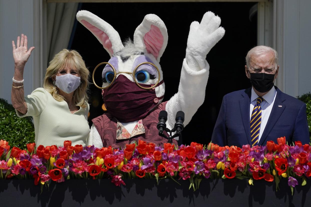 President Biden appears with First Lady Jill Biden and the Easter Bunny on the Blue Room balcony at the White House April 5, 2021, in Washington. 