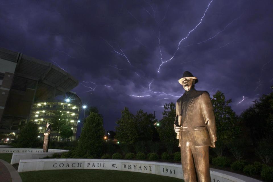 Statues of Paul W. Bryant and Gene Stallings are shown outside Bryant-Denny Stadium during a lightning storm on Aug. 2, 2008. Bryant and Stallings coached football at Texas A&M before coming to the University of Alabama, where both won national championships.
