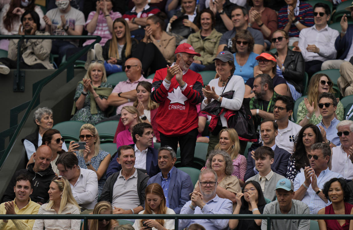 Canadian fans cheer as Denis Shapovalov breaks Karen Khachanov's serve in the fifth set during the men's singles quarterfinals match on day nine of the Wimbledon Tennis Championships in London, Wednesday, July 7, 2021. (AP Photo/Alastair Grant)