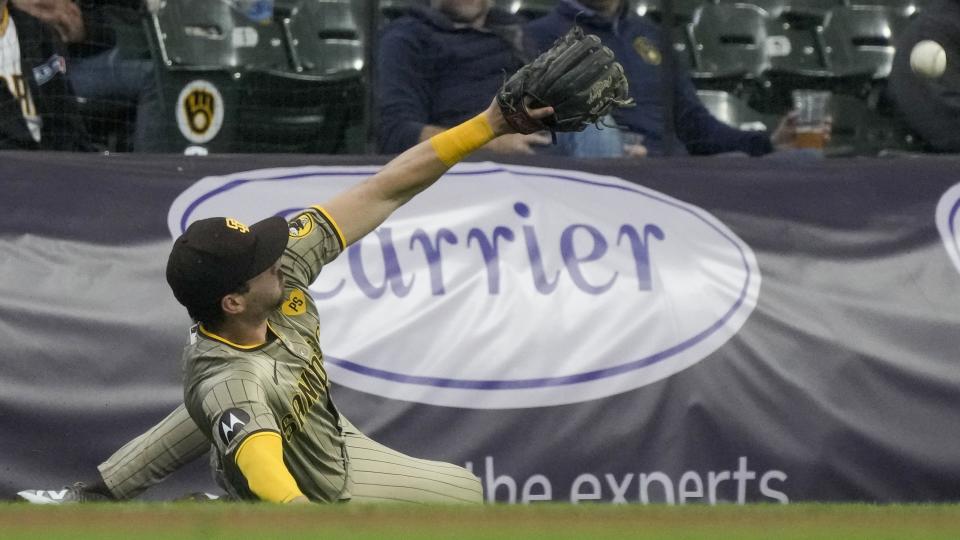 San Diego Padres' Tyler Wade can't catch a foul ball hit by Milwaukee Brewers' Brice Turang during the eighth inning of a baseball game Wednesday, April 17, 2024, in Milwaukee. (AP Photo/Morry Gash)