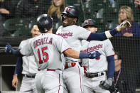 Minnesota Twins' Gio Urshela (15) celebrates with Nick Gordon after they scored on Ueshela's two-run home run off Chicago White Sox starting pitcher Johnny Cueto during the first inning of a baseball game Monday, Oct. 3, 2022, in Chicago. (AP Photo/Charles Rex Arbogast)