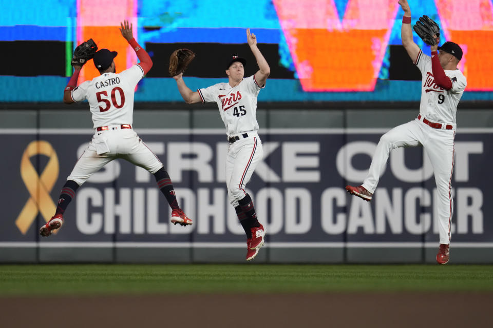 Minnesota Twins left fielder Willi Castro (50), center fielder Andrew Stevenson (45) and right fielder Trevor Larnach (9) celebrate after winning a baseball game against the Oakland Athletics, Wednesday, Sept. 27, 2023, in Minneapolis. (AP Photo/Abbie Parr)