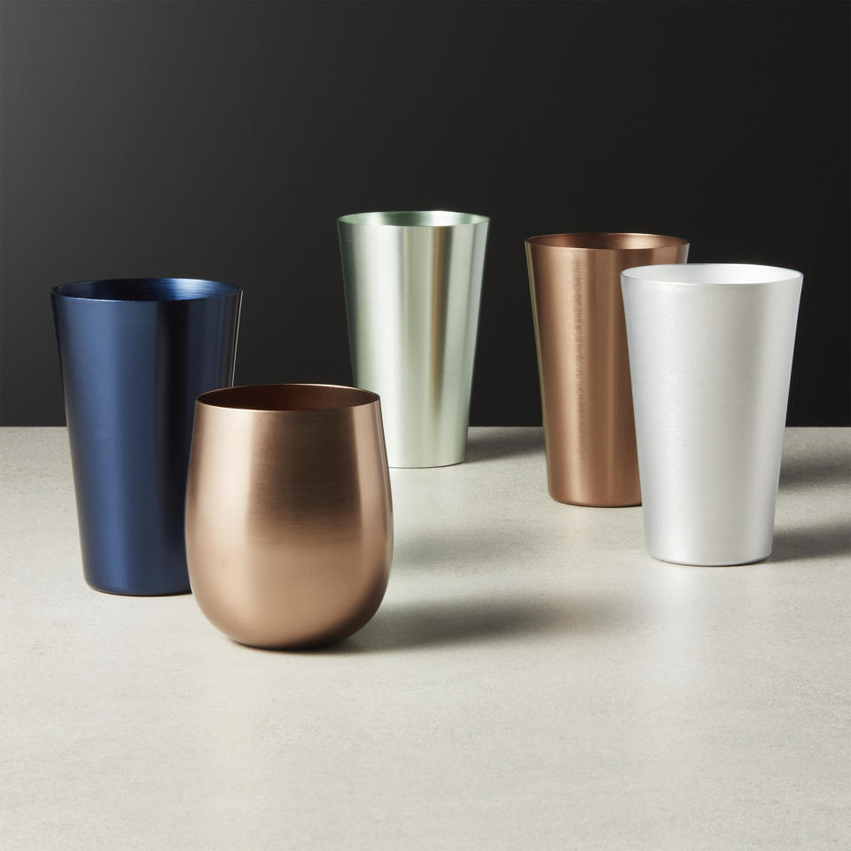 This undated photo shows CB2's Doris matte-finish aluminum tumblers in navy, copper, silver and soft mint green. (CB2 via AP)