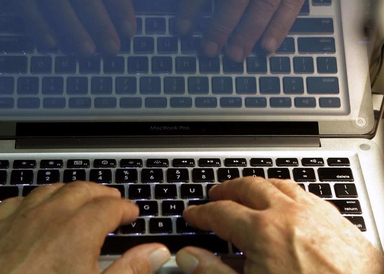 A person in Los Angeles types on a computer keyboard in this file photo illustration.