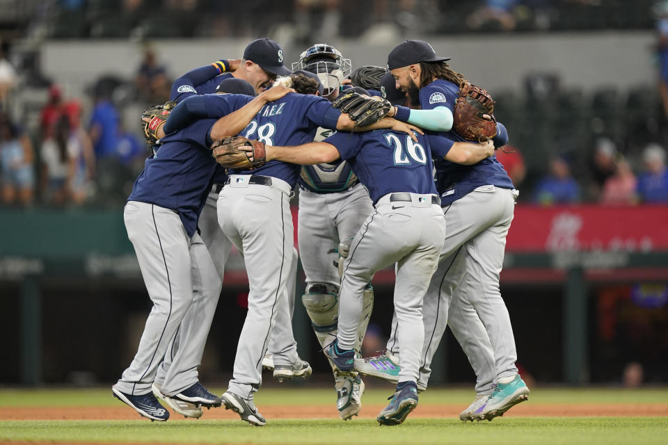 The Seattle Mariners dance in a circle after the final out of the baseball game against the Texas Rangers in Arlington, Texas, Sunday, July 17, 2022. The Mariners won 6-2. (AP Photo/LM Otero)