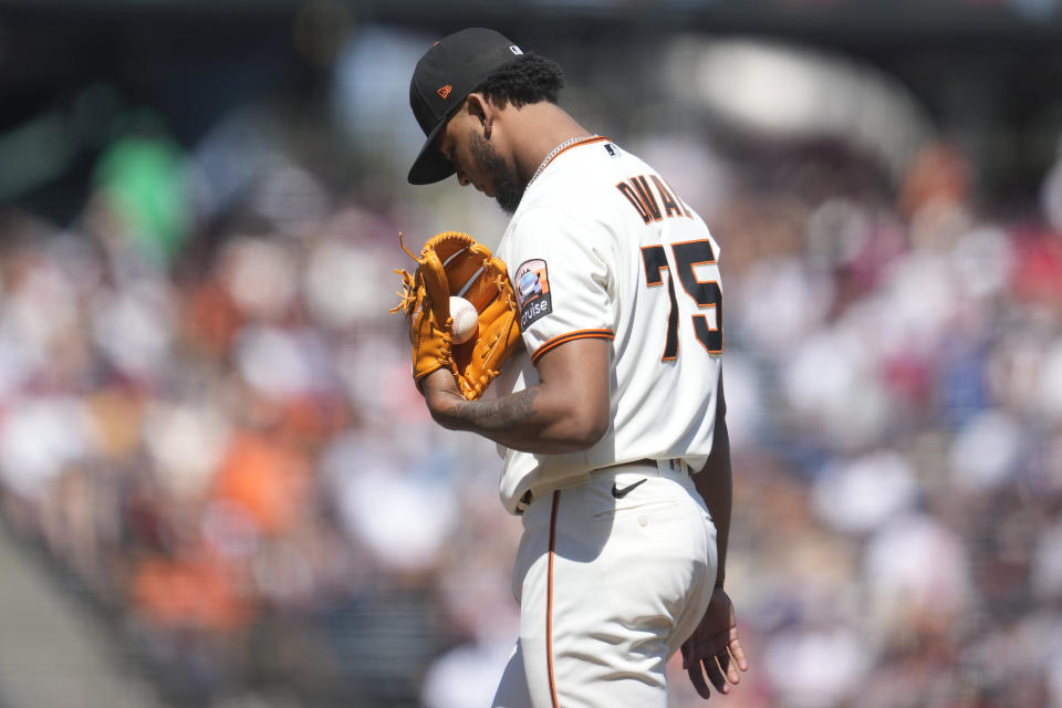 San Francisco Giants pitcher Camilo Doval reacts after being called for a balk that scored Texas Rangers' Ezequiel Duran during the tenth inning of a baseball game in San Francisco, Sunday, Aug. 13, 2023. (AP Photo/Jeff Chiu)