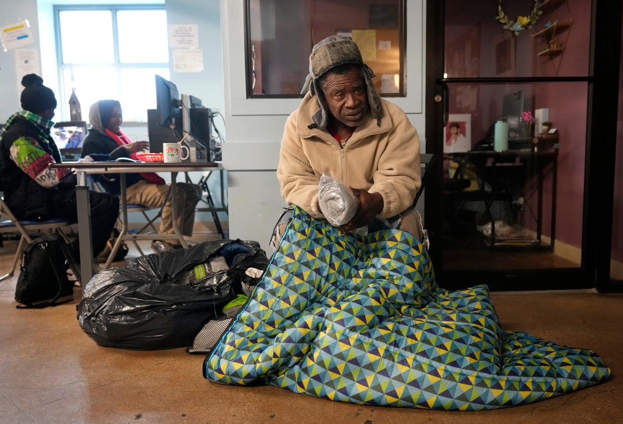 Edward Butler, who is homeless, gets a donated blanket at the Trinity Center on Thursday in anticipation of the arctic blast. The city of Austin plans to operate emergency shelters, but some advocates are concerned about accessibility and the registration process.