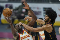 Atlanta Hawks' Clint Capela, left, and Cleveland Cavaliers' Jarrett Allen battle for a loose ball in the first half of an NBA basketball game, Tuesday, Feb. 23, 2021, in Cleveland. (AP Photo/Tony Dejak)