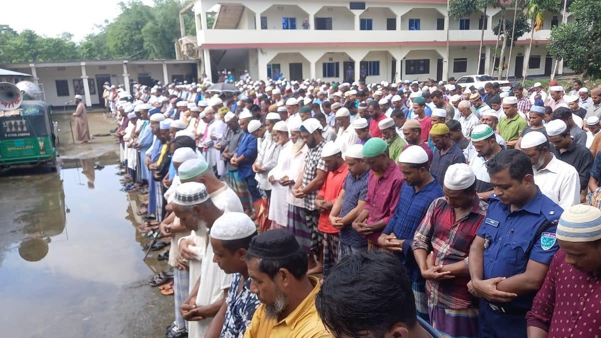 Mourners gather in Bangladesh to offer the funeral prayer for British father and son who died of suspected poisoning  (PA)