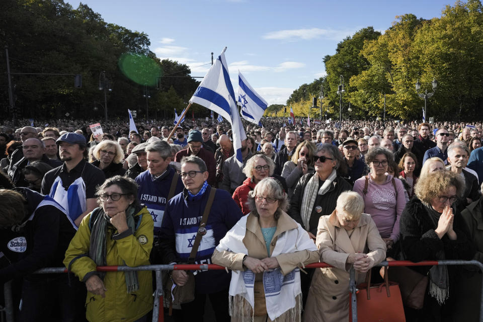 People wave Israeli flags during a demonstration against antisemitism and to show solidarity with Israel in Berlin, Germany, Sunday, Oct. 22, 2023. (AP Photo/Markus Schreiber)