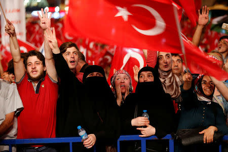 Supporters of Turkish President Tayyip Erdogan shout slogans and wave Turkish national flags during a pro-government demonstration on Taksim square in Istanbul, Turkey, July 18, 2016. REUTERS/Ammar Awad