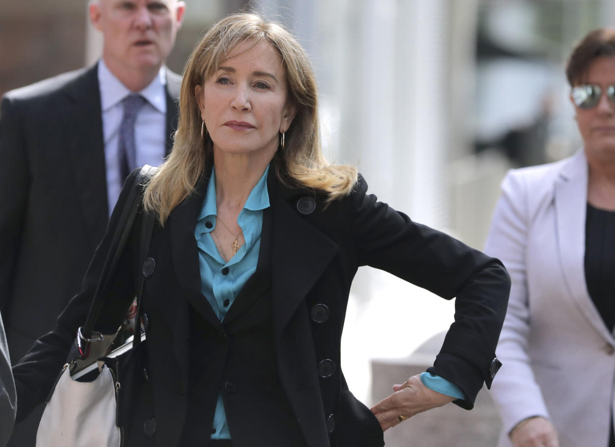 Actress Felicity Huffman arrives at federal court in Boston on Wednesday, April 3, 2019, to face charges in a nationwide college admissions bribery scandal. (AP Photo/Charles Krupa)