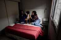 Agustina Ancales and her partner Pablo Vazquez pose for a photo with their dog Sigmoide in Lomas de Zamora, Argentina, Wednesday, Sept. 8, 2021. Ancales' mother got the dog for the couple as a gift after Vazquez was diagnosed with cancer during the COVID-19 lockdown to try to cheer them up. (AP Photo/Natacha Pisarenko)