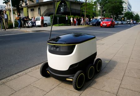 A Starship Technologies commercial delivery robot navigates a pavement during a live demonstration in front of the headquarters of Metro AG in Duesseldorf, Germany, June 7, 2016. REUTERS/Wolfgang Rattay/File Photo