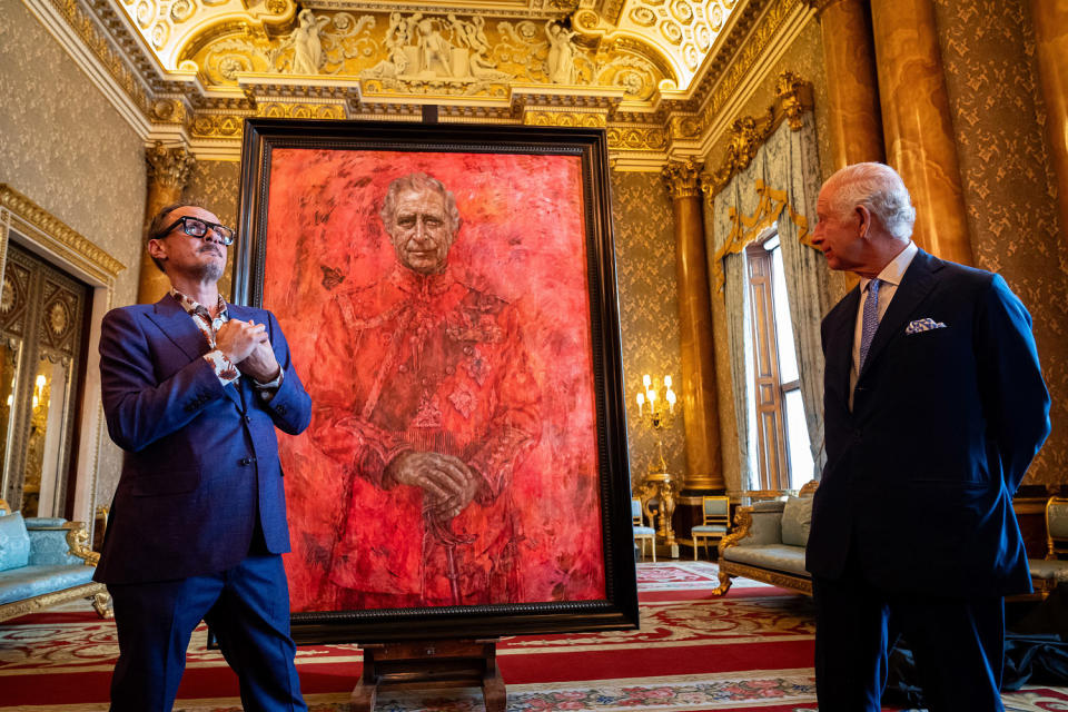 Artist Jonathan Yeo and King Charles III stand in front of the portrait of the King Charles III as it is unveiled in the blue drawing room at Buckingham Palace. The artwork depicts the King wearing the uniform of the Welsh Guards, of which he was made Regimental Colonel in 1975. The canvas size - approximately 8.5 by 6.5 feet when framed - was carefully considered to fit within the architecture of Drapers' Hall and the context of the paintings it will eventually hang alongside. (Aaron Chown / Getty Images)