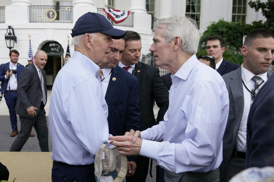President Joe Biden speaks with Sen. Rob Portman, R-Ohio, as he departs the Congressional Picnic on the South Lawn of the White House, Tuesday, July 12, 2022, in Washington. (AP Photo/Patrick Semansky)