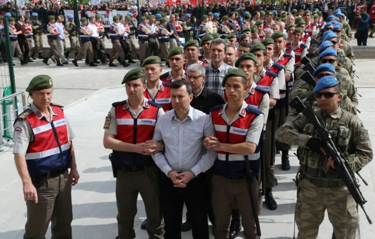 Turkish soldiers accused of being involved in an attempted coup d'etat on 15 July 2016 are led to the court inside the Sincan Prison in Ankara, for their trial, in May 2017