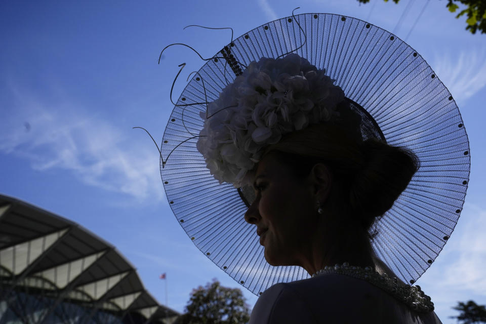 A racegoer poses for a photo, on the second day of of the Royal Ascot horserace meeting, at Ascot Racecourse, in Ascot, England, Wednesday, June 15, 2022. (AP Photo/Alastair Grant)