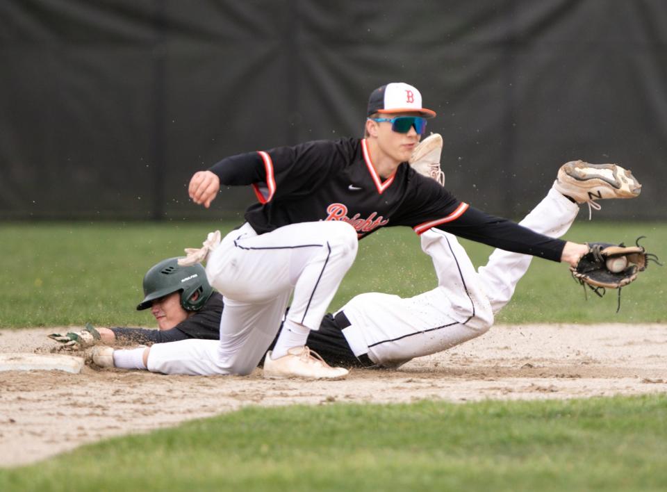 Howell's Phil Hampton slides safely into second base as Brighton's Cooper Andrzejewski catches the ball Wednesday, May 4, 2022.