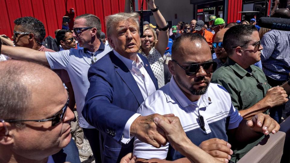 PHOTO: Former President Donald Trump, 2024 Republican presidential candidate greets attendees while touring the Iowa State Fair in Des Moines, Iowa, Aug. 12, 2023. (Rachel Mummey/Bloomberg via Getty Images)