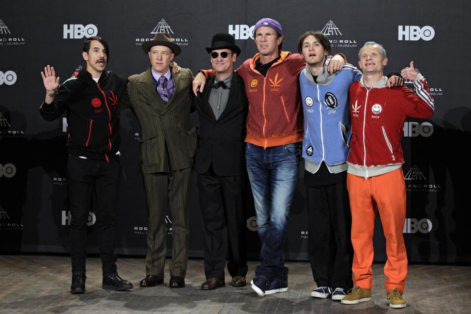 Current and former members of the Red Hot Chili Peppers appear in the press room before induction into the Rock and Roll Hall of Fame induction ceremonies Friday, April 13, 2012, in Cleveland. From left: , Anthony Kiedis, Jack Irons, Cliff Martinez, Chad Smith, Josh Klinghoffer and Flea. (AP Photo/Amy Sancetta)