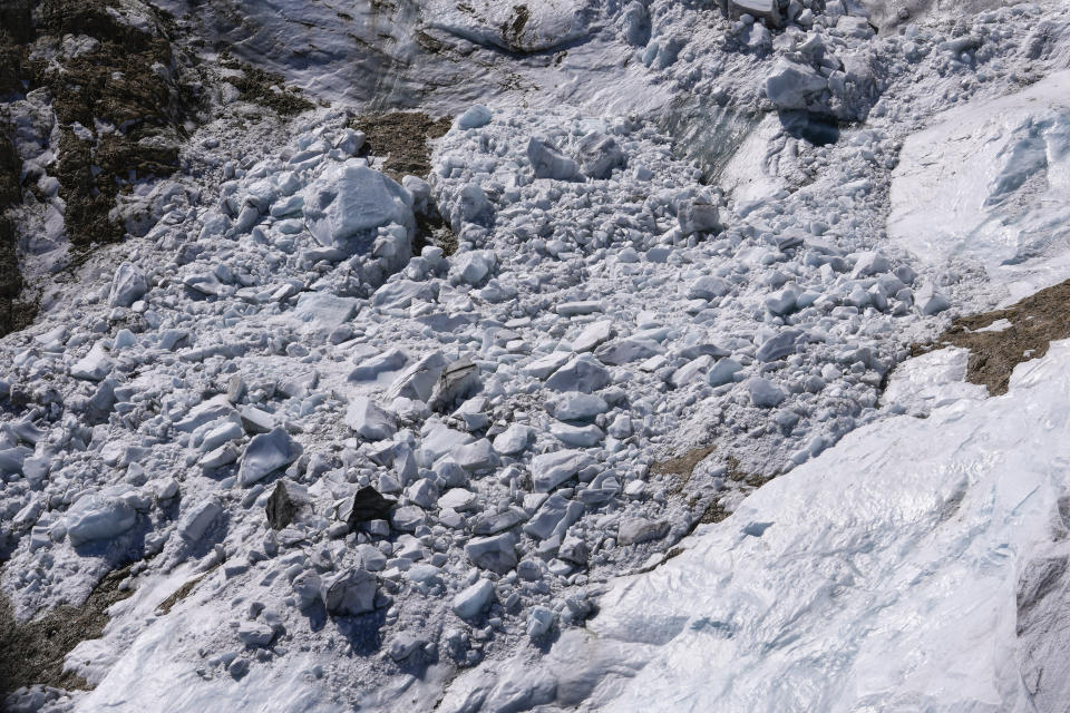 Debris and blocks of ice are seen on the Punta Rocca glacier near Canazei, in the Italian Alps in northern Italy, Tuesday, July 5, 2022, two days after a huge chunk of the glacier broke loose, sending an avalanche of ice, snow, and rocks onto hikers. Italy was enduring a prolonged heat wave before a massive piece of the Alpine glacier broke off and killed hikers on Sunday and experts say climate change will make those hot, destabilizing conditions more common. (AP Photo/Luca Bruno)