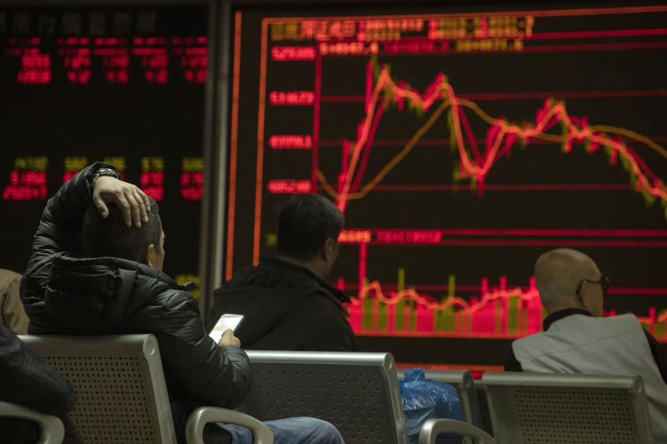 Investors monitors stock prices at a brokerage in Beijing on Thursday, Dec. 12, 2019. Asian shares are mixed after a wobbly day on Wall Street following the Federal Reserve announcement that it would leave interest rates unchanged. Japan's benchmark Nikkei 225, South Korea's Kospi and Hong Kong's Hang Seng rose in early Thursday trading. (AP Photo/Ng Han Guan)