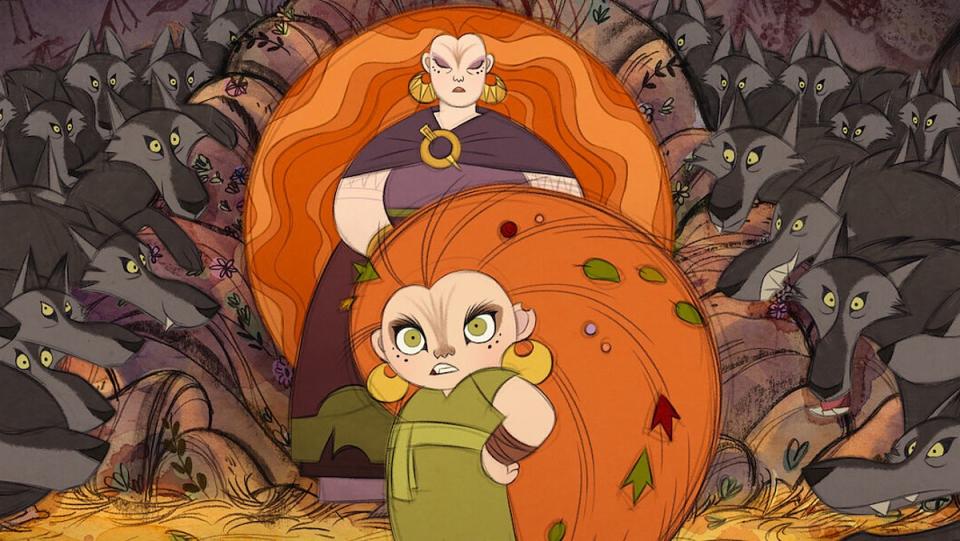 A redheaded girl stands before a redheaded woman and they are surrounded by wolves in a still from the animated film Wolfwalkers from Cartoon Saloon.