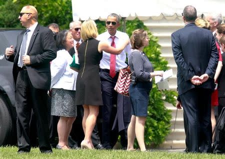 U.S. President Barack Obama (C) greets people as he returns to the White House after the Memorial Day observance at Arlington National Cemetery in Washington, U.S., May 30, 2016. REUTERS/Yuri Gripas