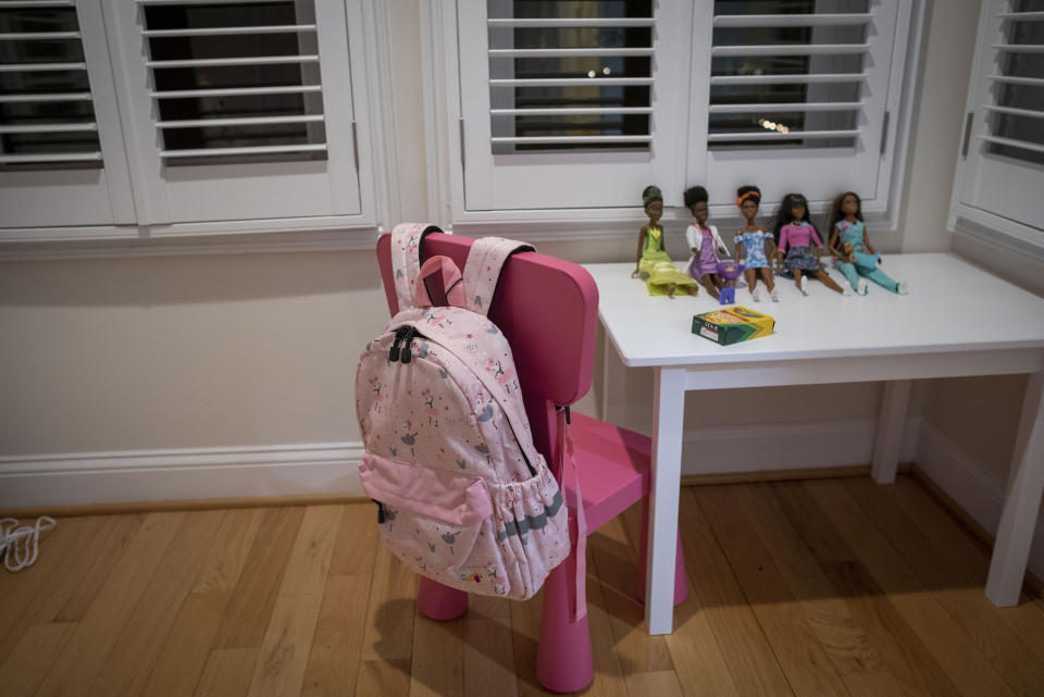 Dolls and a backpack sit in the bedroom set up for Gina, a six-year-old Haitian girl who has been adopted by Bryan and Julie Hanlon, to use when she arrives to their home in Washington D.C., Tuesday, Feb. 7, 2023. The Hanlons became the legal parents of Gina and her five-year-old brother Peterson in 2022 but fear they won't be able to secure their passports and fly them out of Haiti. (AP Photo/Cliff Owen)