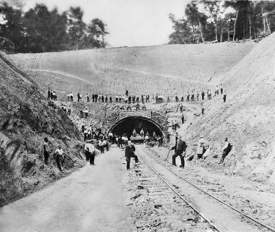 FILE - Andrew Carnegie, shown in the center, in front of Rays Hill Tunnel in 1885 which was being dug in Pennsylvania for a railroad he and others were building along the route the Pennsylvania Turnpike now follows. (AP Photo, File)
