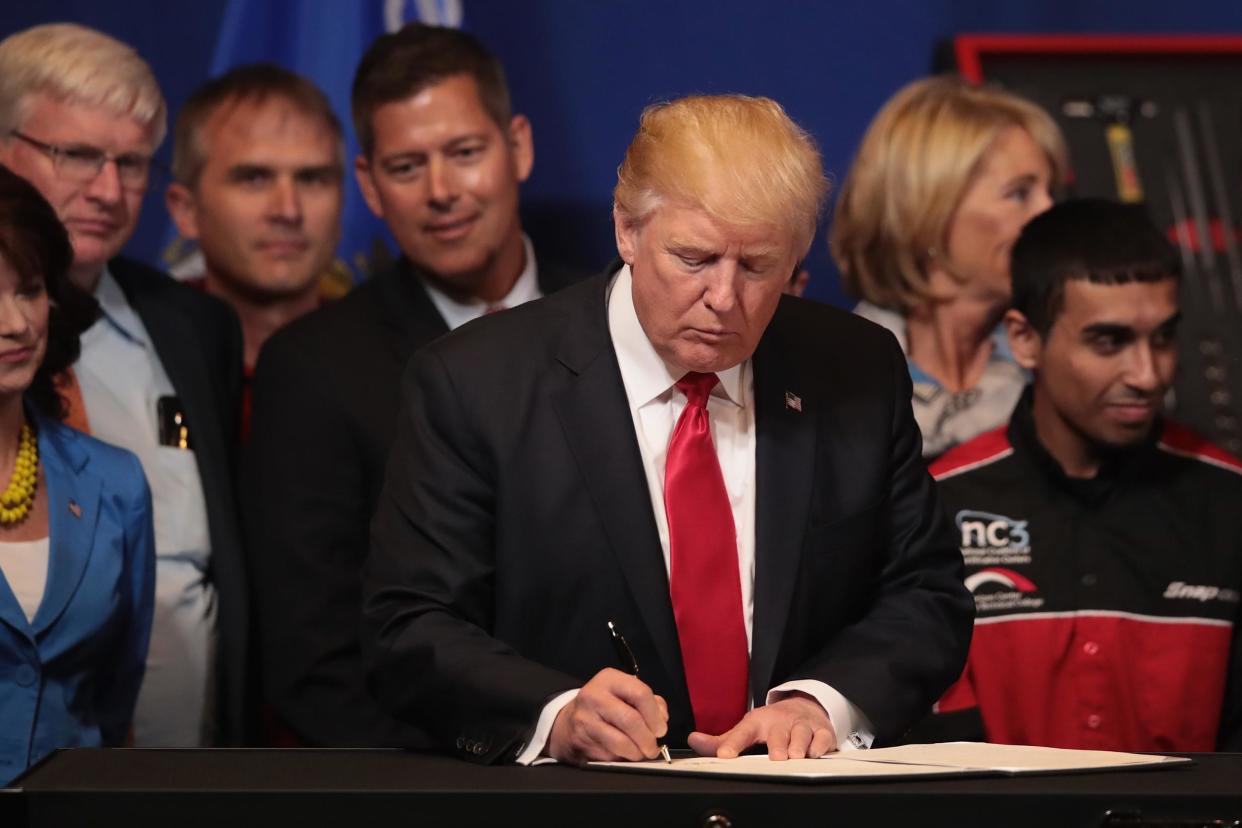 President Donald Trump signs an executive order to revamp the H-1B visa guest worker program: Scott Olson/Getty Images