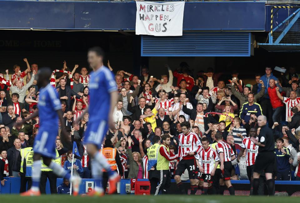 Sunderland players celebrate their second goal against Chelsea during their English Premier League soccer match at the Stamford Bridge ground in London, Saturday April 19, 2014. Sunderland won the match 2-1. (AP Photo/Lefteris Pitarakis)