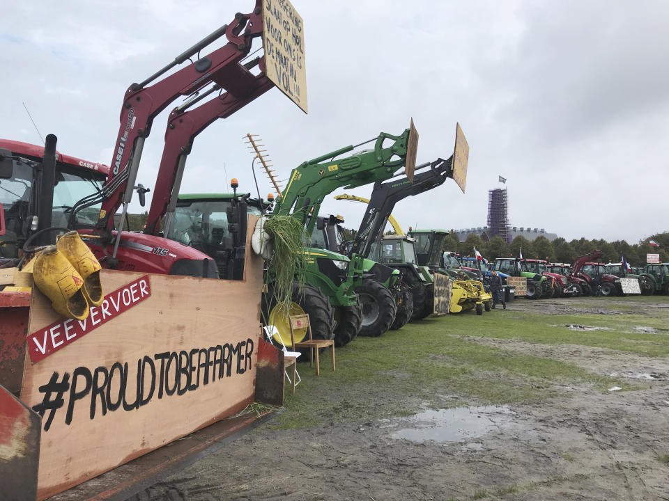 Tractors are lined up during a protest in The Hague, Netherlands, Tuesday, Oct. 1, 2019, as thousands of Dutch farmers headed to The Hague on Tuesday, many driving in slow-moving convoys of tractors that snarled traffic in the morning rush hour, for a national day of protest to demand more respect for their profession. (AP Photo/Mike Corder)