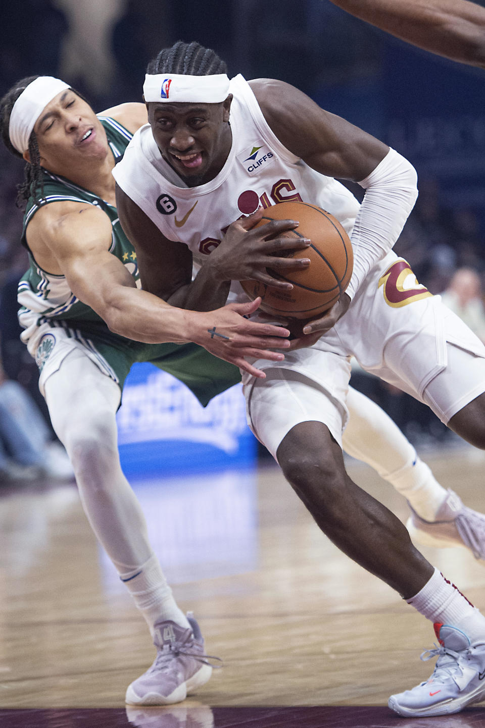 Cleveland Cavaliers' Caris LeVert, with ball, drives past Detroit Pistons' R.J. Hampton during the first half of an NBA basketball game in Cleveland, Saturday, March 4, 2023. (AP Photo/Phil Long)