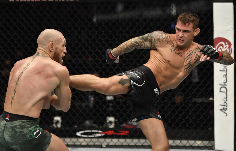 Dustin Poirier kicks Conor McGregor of Ireland in a lightweight fight during the UFC 257 event in January 2021