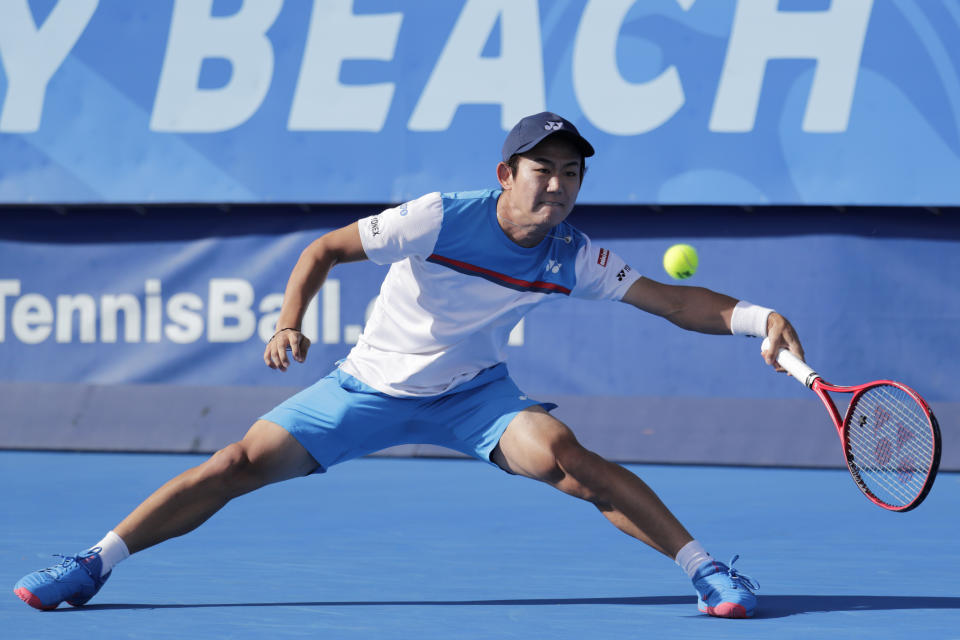 Yoshihito Nishioka, of Japan, returns to Reilly Opelka, during the Delray Beach Open singles final tennis match, Sunday, Feb. 23, 2020, in Delray Beach, Fla. (AP Photo/Lynne Sladky)