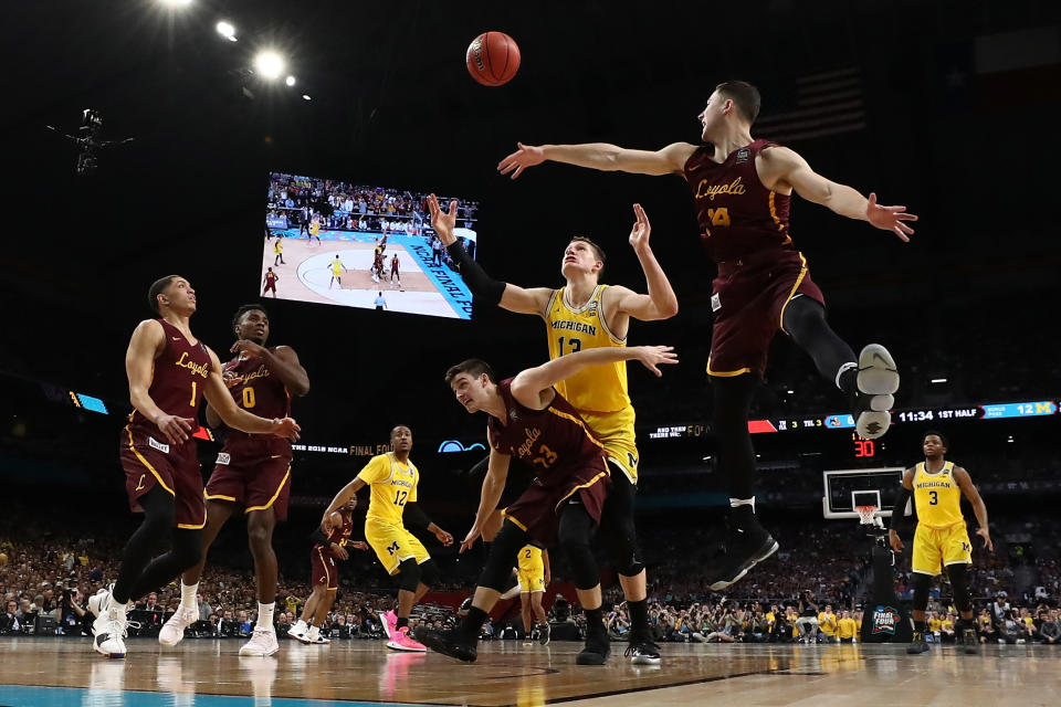 <p>Moritz Wagner #13 of the Michigan Wolverines competes for the ball with Clayton Custer #13 and Ben Richardson #14 of the Loyola Ramblers in the first half during the 2018 NCAA Men’s Final Four Semifinal at the Alamodome on March 31, 2018 in San Antonio, Texas. (Photo by Tom Pennington/Getty Images) </p>