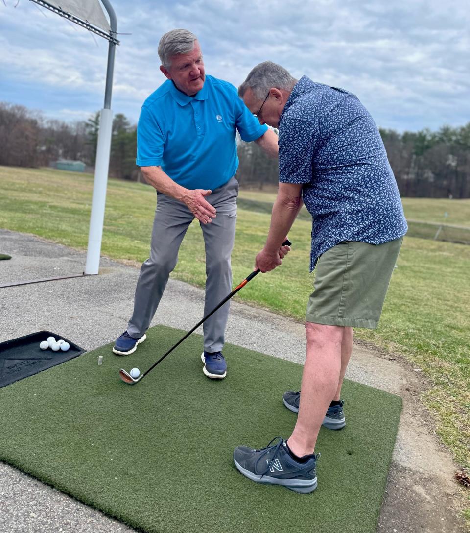 Rick Karbowski offers tips to Auburn's Jerry Hastings during a recent golf lesson at Auburn Driving Range.